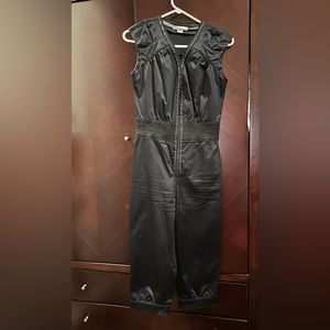 Black, detailed romper with rhinestones zipper front.